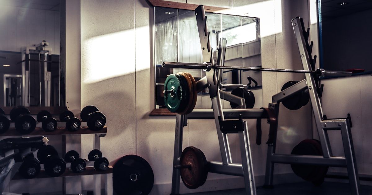 Barbell loaded on a rack in a gym, ready for strength training