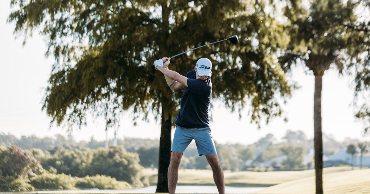 Golfer performing a mobility assessment stretch to evaluate range of motion