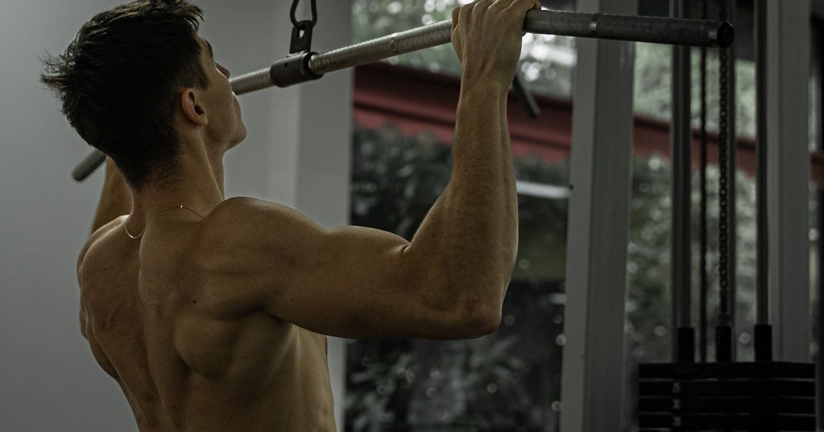 Athlete performing a lat pulldown exercise at the gym
